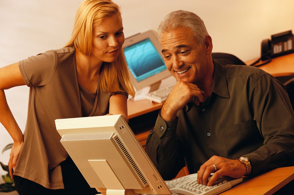 Man and woman looking at a monitor